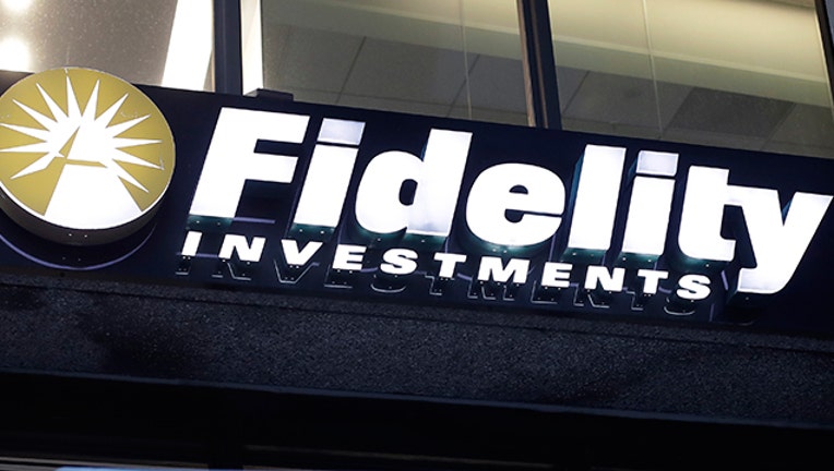 In this Oct. 14, 2019 file photo a Fidelity Investments logo is attached to a building, in Boston. Fidelity is launching a new type of account for teenagers to save, spend and invest their money. The account is for 13- to 17-year-olds, and it will allow them to deposit cash, have a debit card and trade stocks and funds. (AP Photo/Steven Senne, File)