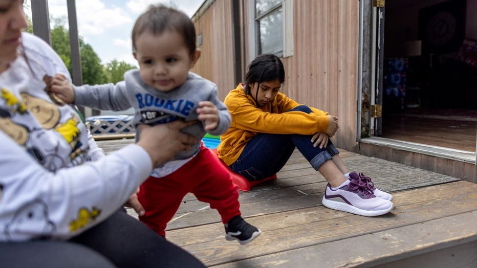 Honduran immigrant Nani, 10, pauses after moving in with her extended family