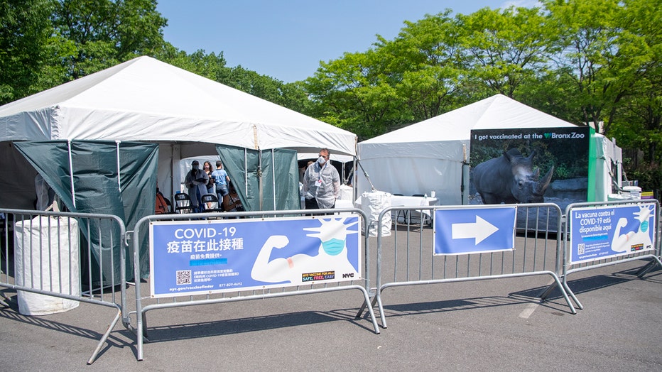 Temporary medical tents and metal barricades in a parking lot at the Bronx Zoo