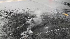 Lightning strike leaves giant, smoldering hole in street after storm