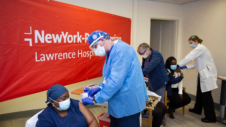 Doctors inject sisters Claudia Scott-Mighty, left, Althea Scott-Bonaparte, who are patient care directors, and Christine Scott, an ICU nurse, with their second shot of the Pfizer vaccine at NewYork-Presbyterian Lawrence Hospital on Friday, Jan. 8, 2021, in Bronxville, N.Y.