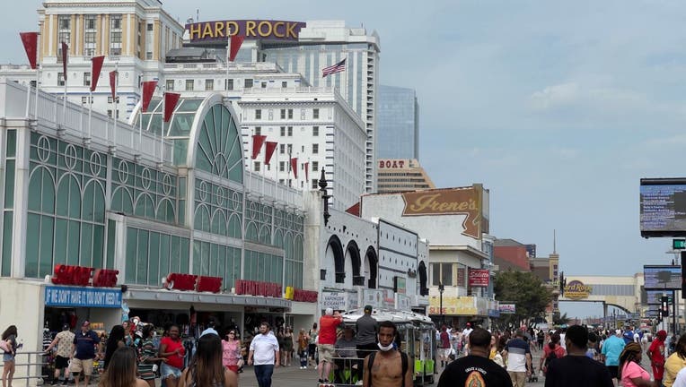 People walk on the boardwalk in Atlantic City, New Jersey