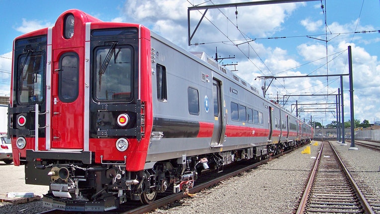 A commuter train in a rail yard