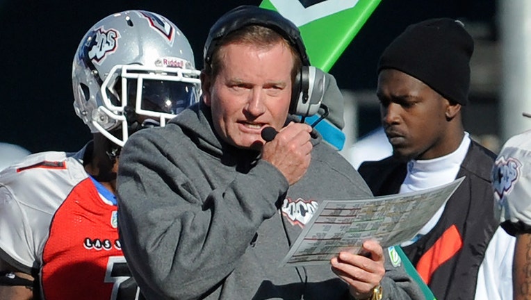 FILE - In this Nov. 27, 2010, file photo, then Las Vegas head coach Jim Fassel, center, looks on from the sideline during their United Football League title game against Florida in Omaha, Neb.