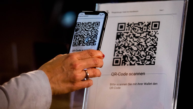 A ID wallet is on display on the screen of a mobile phone at a hotel in Berlin, Germany.(Photo by Filip Singer-Pool/Getty Images)
