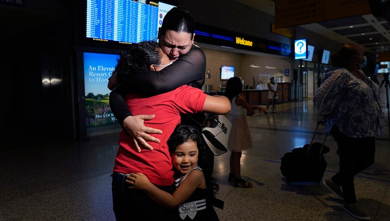 Emely, left, is reunited with her mother, Glenda Valdez and sister, Zuri, at Austin-Bergstrom International Airport, Sunday, June 6, 2021, in Austin, Texas.(AP Photo/Eric Gay)