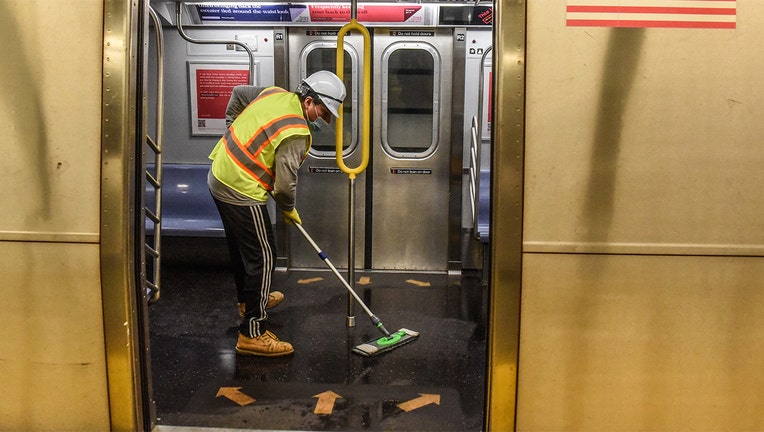 A cleaning crew disinfects a New York City subway train on May 4, 2020 in New York City. (Photo by Stephanie Keith/Getty Images)