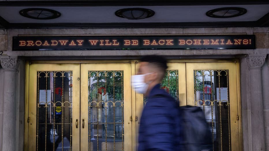 People walk past a closed Broadway theater on May 6, 2021 in New York City.