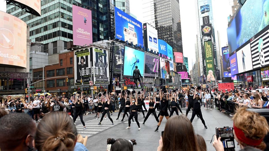 People gather around to watch dancers during the 