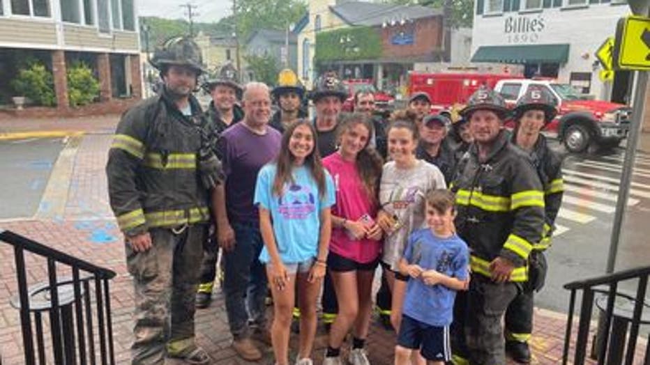 Officials say she was not injured. Photos show her smiling as she poses with the rescuers after the ordeal.