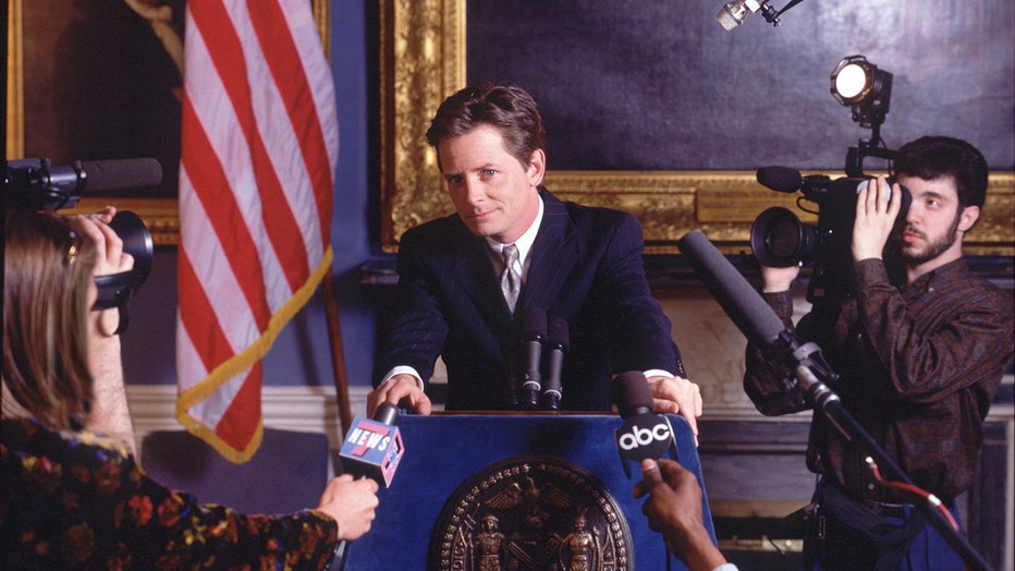 This 1996 photo shows Michael J. Fox on the situation Spin City. The comedy takes place in New York's City Hall. It centers on Fox (as Mike Flaherty, the deputy mayor), who has to protect the slightly moronic mayor, Randall Winston from those who want to ruin his political career, and from himself. (Photo by Timothy White/Walt Disney Television via Getty Images) MICHAEL J. FOX