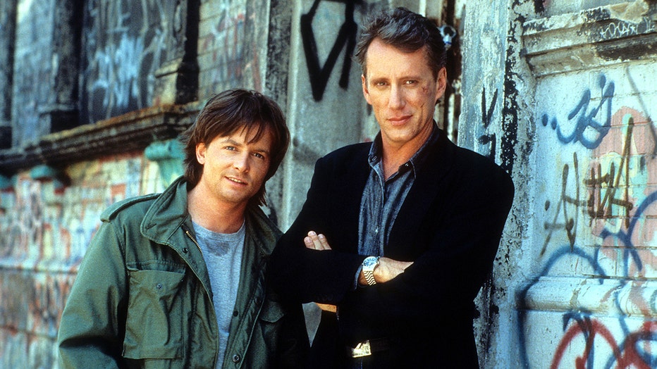 Michael J Fox and James Woods on the street in a scene from the film 'The Hard Way', 1991. (Photo by Universal/Getty Images)