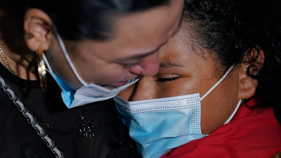 Emely, right, is reunited with her mother, Glenda Valdez at Austin-Bergstrom International Airport, Sunday, June 6, 2021, in Austin, Texas. It had been six years since Valdez said goodbye to her daughter Emely in Honduras. Then, last month, she caught a glimpse of a televised Associated Press photo of a little girl in a red hoodie and knew that Emely had made the trip alone into the United States. On Sunday, the child was returned to her mother’s custody. (AP Photo/Eric Gay)