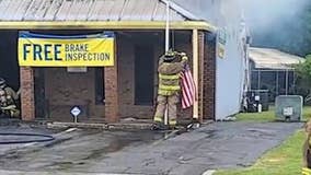 Firefighter saves flag as flames creep toward it