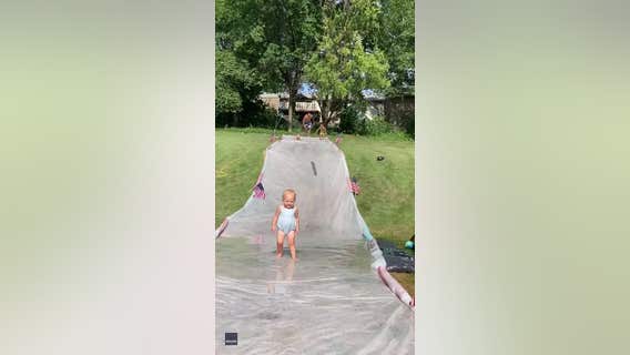 Dad with lightning-fast reflexes catches toddler on slip ‘n slide