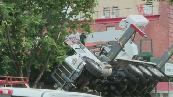 Construction crane collapses onto Queens building, store