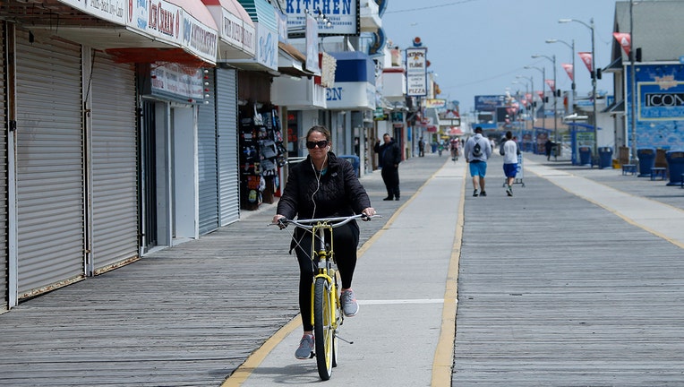 A woman biking along a boardwalk