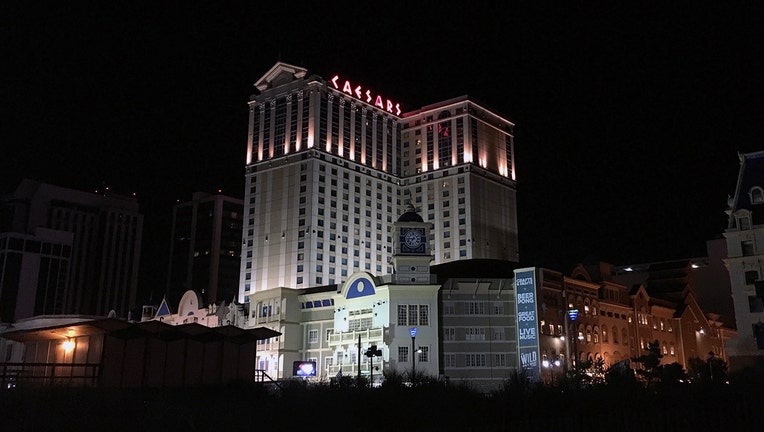 Caesars casino along the Atlantic City boardwalk illuminated at night
