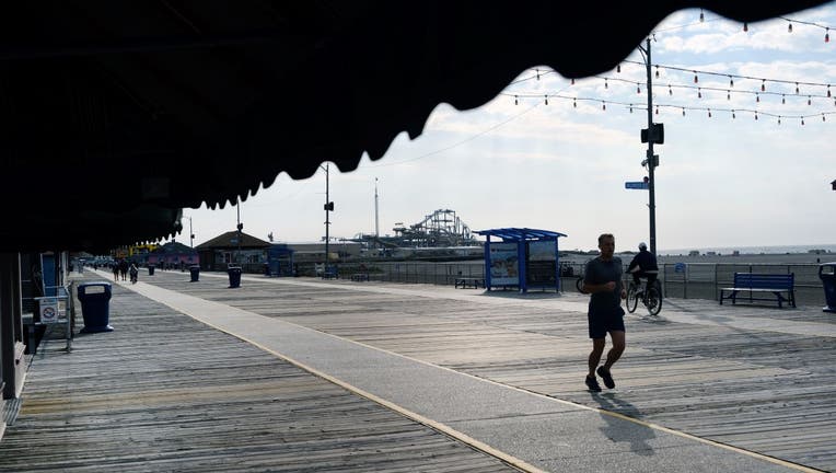 People walk and ride along the boardwalk