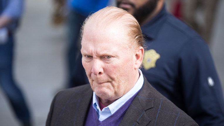 Closeup of Mario Batali outside court; he wears a light blue collared shirt