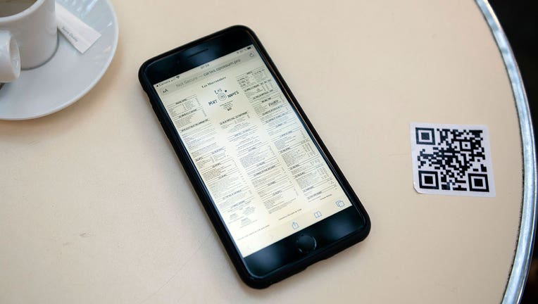 A menu linked from a QR code is shown on a smartphone. ((Photo by Aurelien Meunier/Getty Images)