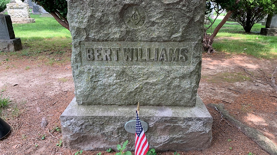 headstone with the name "Bert Williams"; a small American flag stands in front