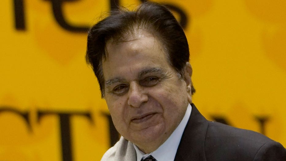 In this Sept. 2, 2008, file photo, veteran Bollywood actor Dilip Kumar, right, receives a Lifetime Achievement award at the 54th National Film Award ceremony in New Delhi, India. Kumar, hailed as the 