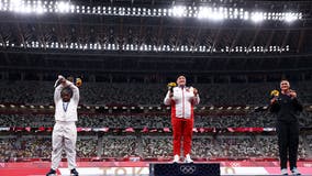 US shot putter Raven Saunders makes 'X' in podium pose after winning silver