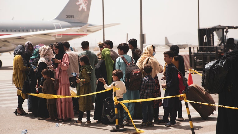 Civilians prepare to board a plane
