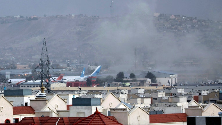 Smoke rises from a deadly explosion outside the airport in Kabul, 