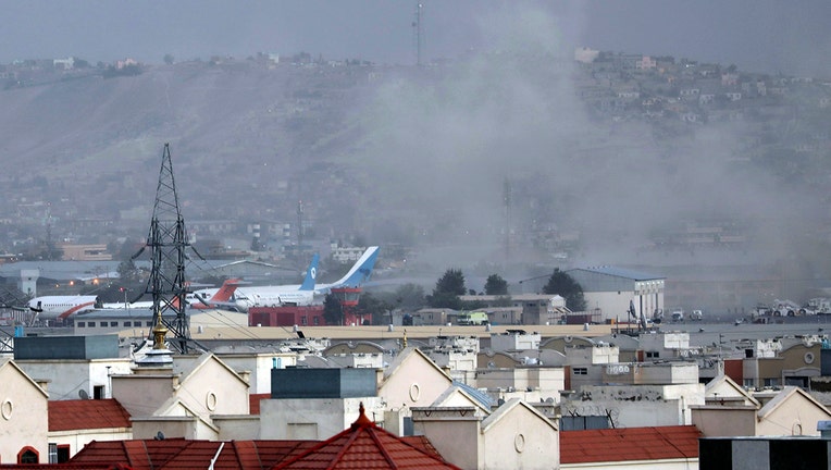 Smoke rises from a deadly explosion outside the airport in Kabul,