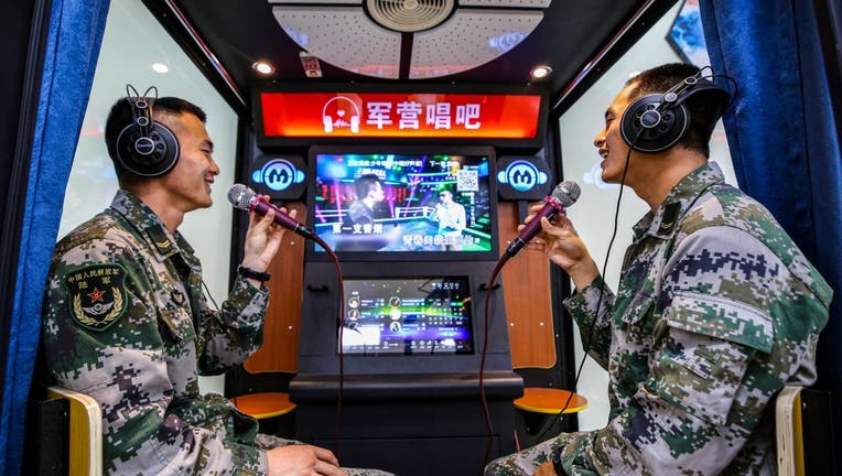Soldiers take part in a karaoke song at a military barracks in Zhenjiang, east China's Jiangsu Province