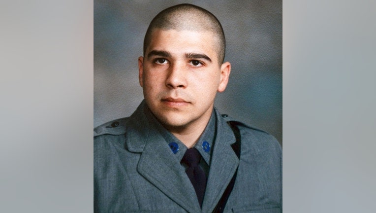 Head-and-shoulders image of a state trooper wearing gray uniform and purple tie