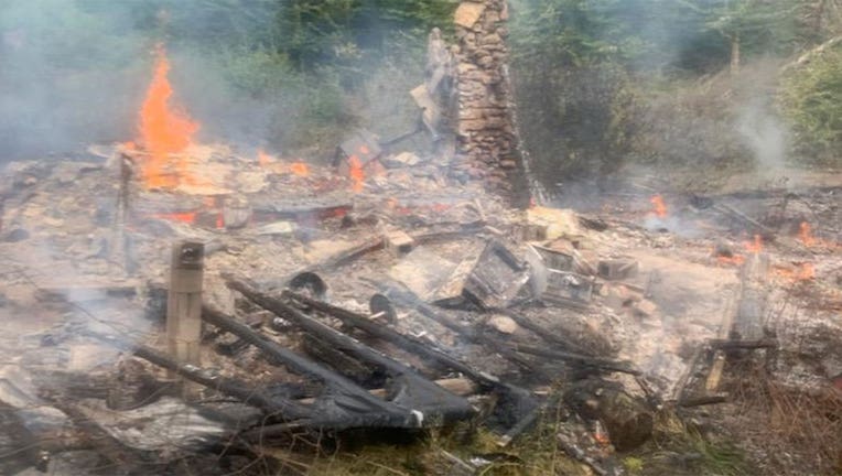 A photo by firefighters shows the burned remains of River Dave's cabin. (Canterbury Fire Department)