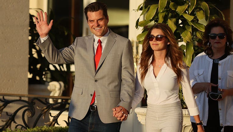 Rep. Matt Gaetz (R-Fl) and Ginger Luckey arrive before he speaks during the "Save America Summit" at the Trump National Doral golf resort on April 09, 2021 in Doral, Florida. (Photo by Joe Raedle/Getty Images)