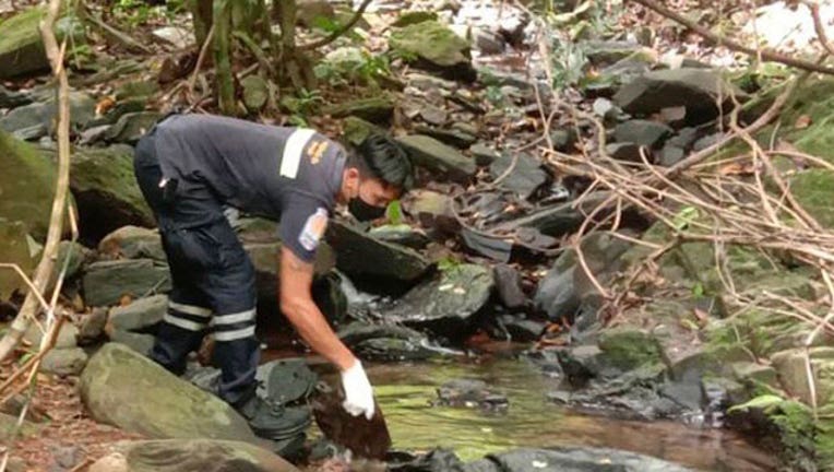  An officer inspects the scene where a woman was found dead at a secluded spot on the southern island of Phuket, Thailand, on Thursday, Aug. 5, 2021. Thai media, quoting police, said the woman was a 57-year-old Swiss national. (AP Photo)