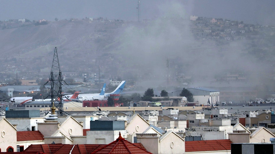 Smoke rises from a deadly explosion outside the airport in Kabul,