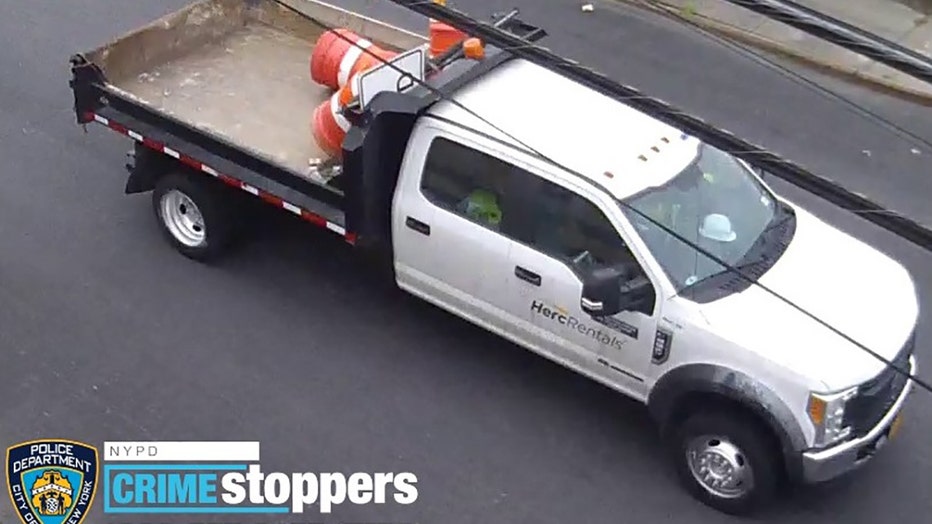 Security camera image of a white flatbed truck