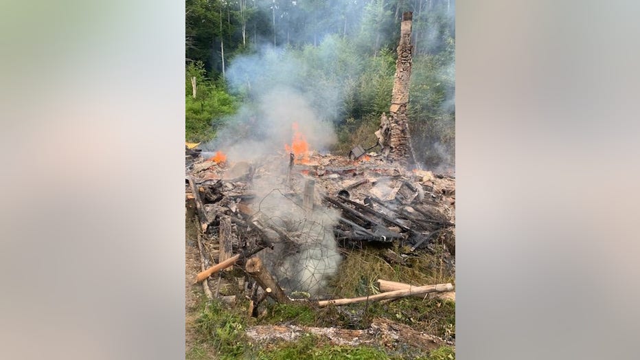 A photo by firefighters shows the burned remains of River Dave's cabin. (Canterbury Fire Department)