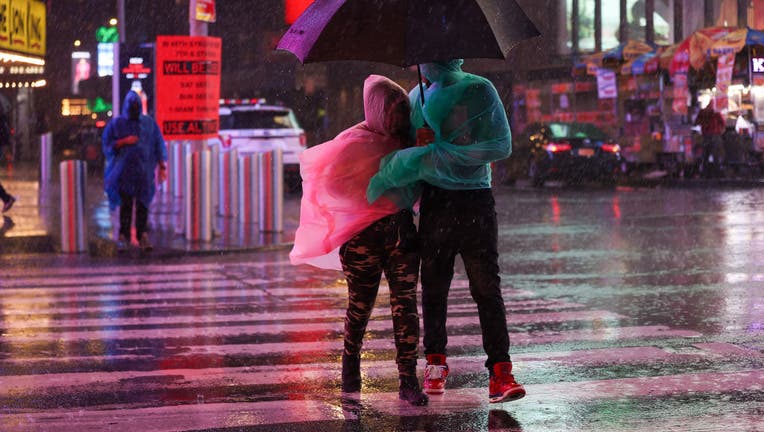 People out in the street during heavy rain and storm at Times Square in New York City, United States on September 1, 2021. (Photo by Tayfun Coskun/Anadolu Agency via Getty Images)