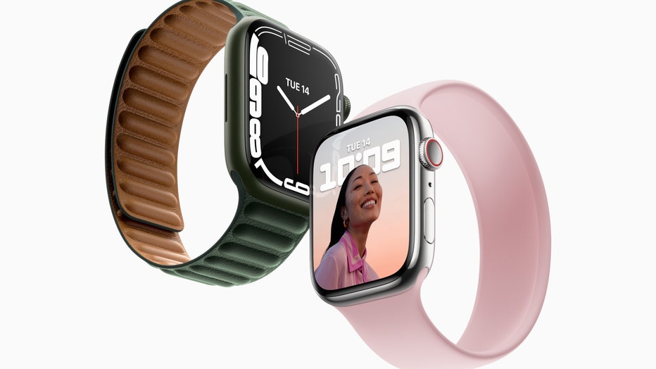 An Apple Watch with a green band and one with a pink band