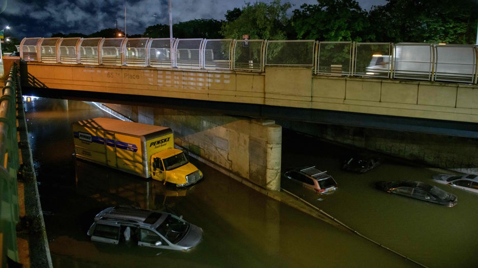 Floodwater surrounds vehicles following heavy rain on an expressway in Brooklyn, New York early on September 2, 2021, as flash flooding and record-breaking rainfall brought by the remnants of Storm Ida swept through the area. (Photo by ED JONES/AFP via Getty Images)