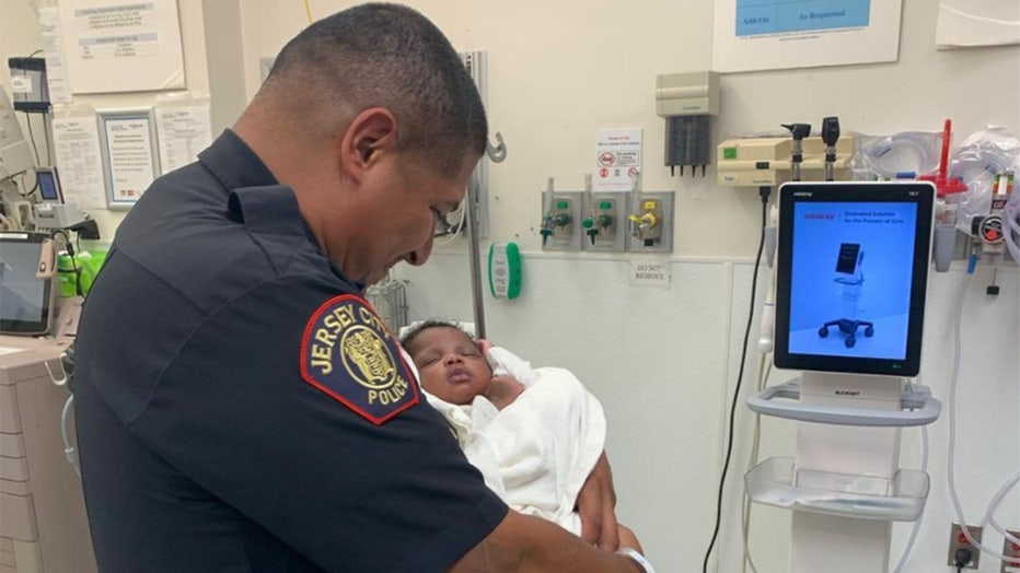 Jersey City Mayor Steve Fulop posted a photo of Officer Eduardo Matute holding the baby he caught.