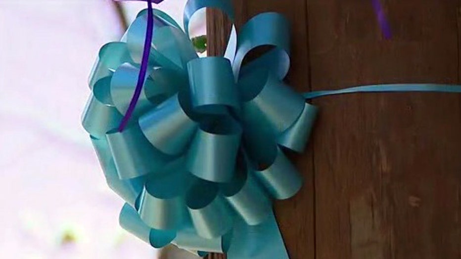 A teal ribbon hangs on a pole in Suffolk County as a sign of support for the family of Gabby Petito.