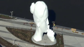 80-foot sculpture of a woman's head installed on Hudson River waterfront