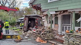 Garbage truck smashes into NY house