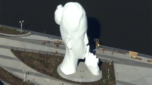 80-foot sculpture of a woman's head installed on Hudson River waterfront
