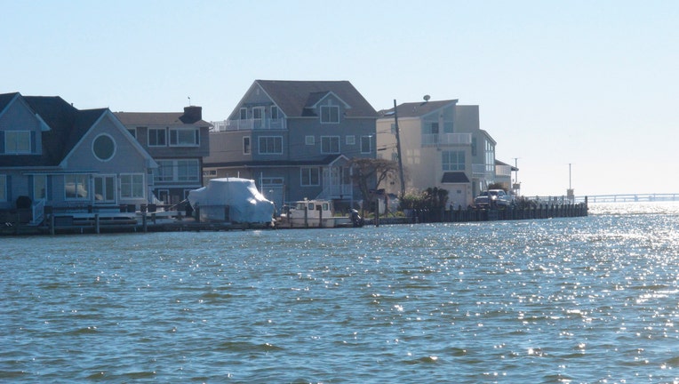 This Oct. 21, 2021, photo shows houses built at the edge of Barnegat Bay in Toms River, N.J. On Tuesday, Oct. 26, 2021, a collection of governments, academics and scientists unveiled a far-reaching plan to improve the health of the bay, which one researcher says "has been loved to death."