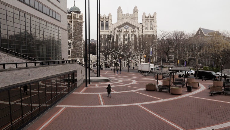 Students walk through the campus of the City College of New York, Friday, Jan. 15, 2016, in New York.