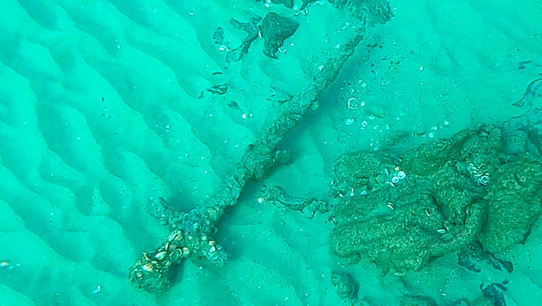 An ancient sword rests on sand in the Mediterranean Sea